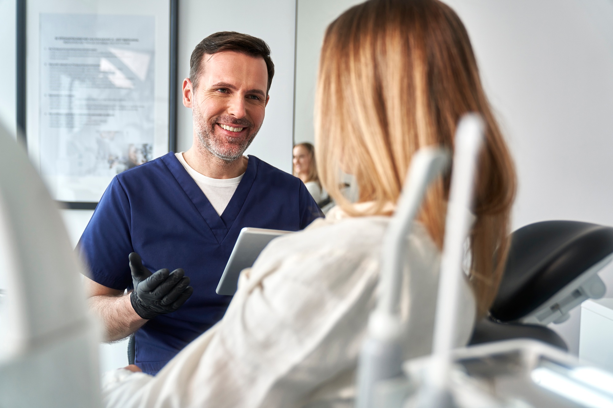 Dentist explaining dental care to a patient