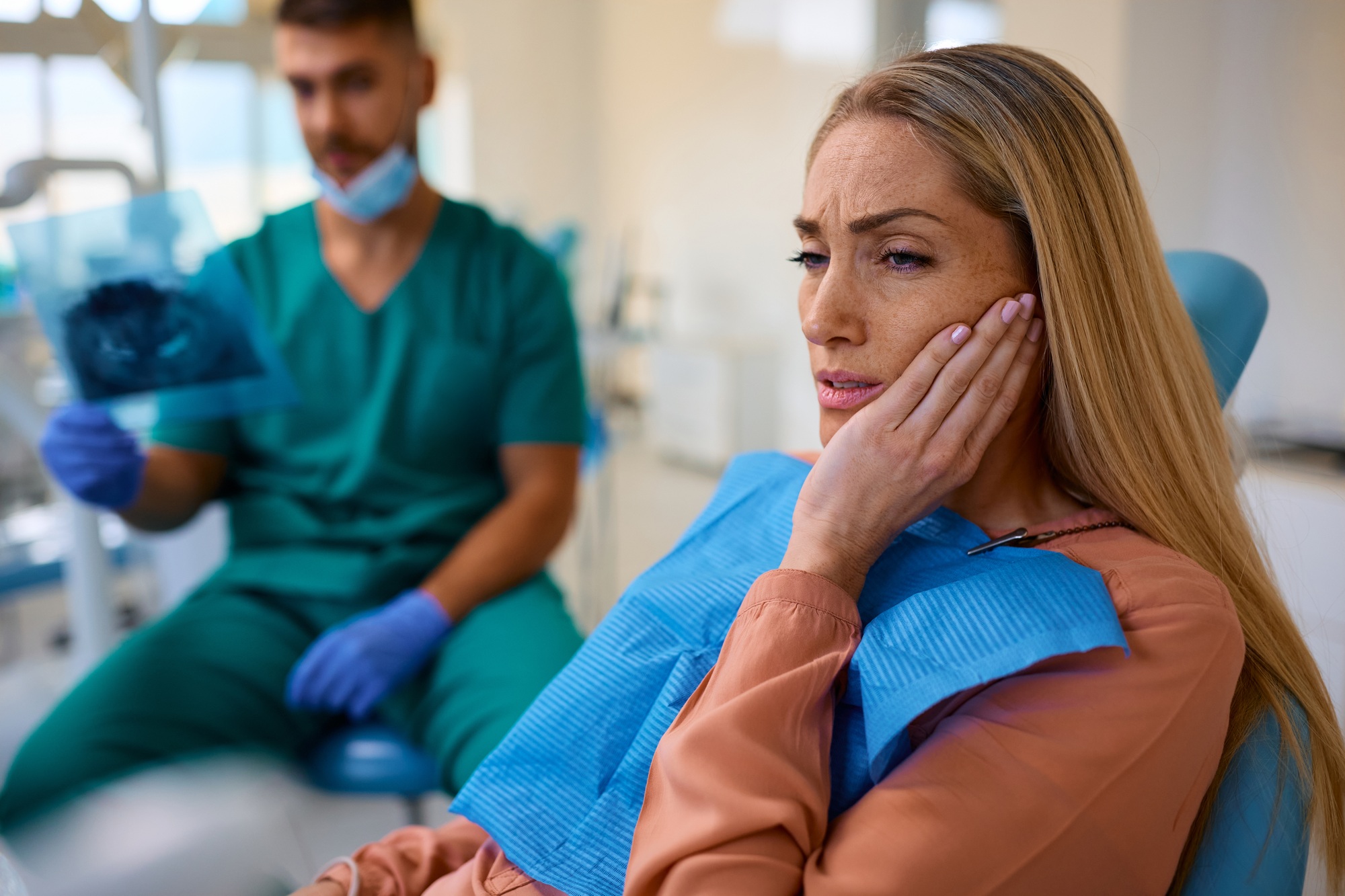 Person with a knocked-out, painful tooth