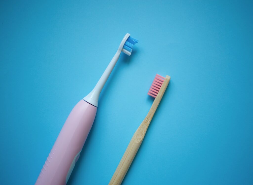 two ultrasonic electric toothbrushes on a blue background