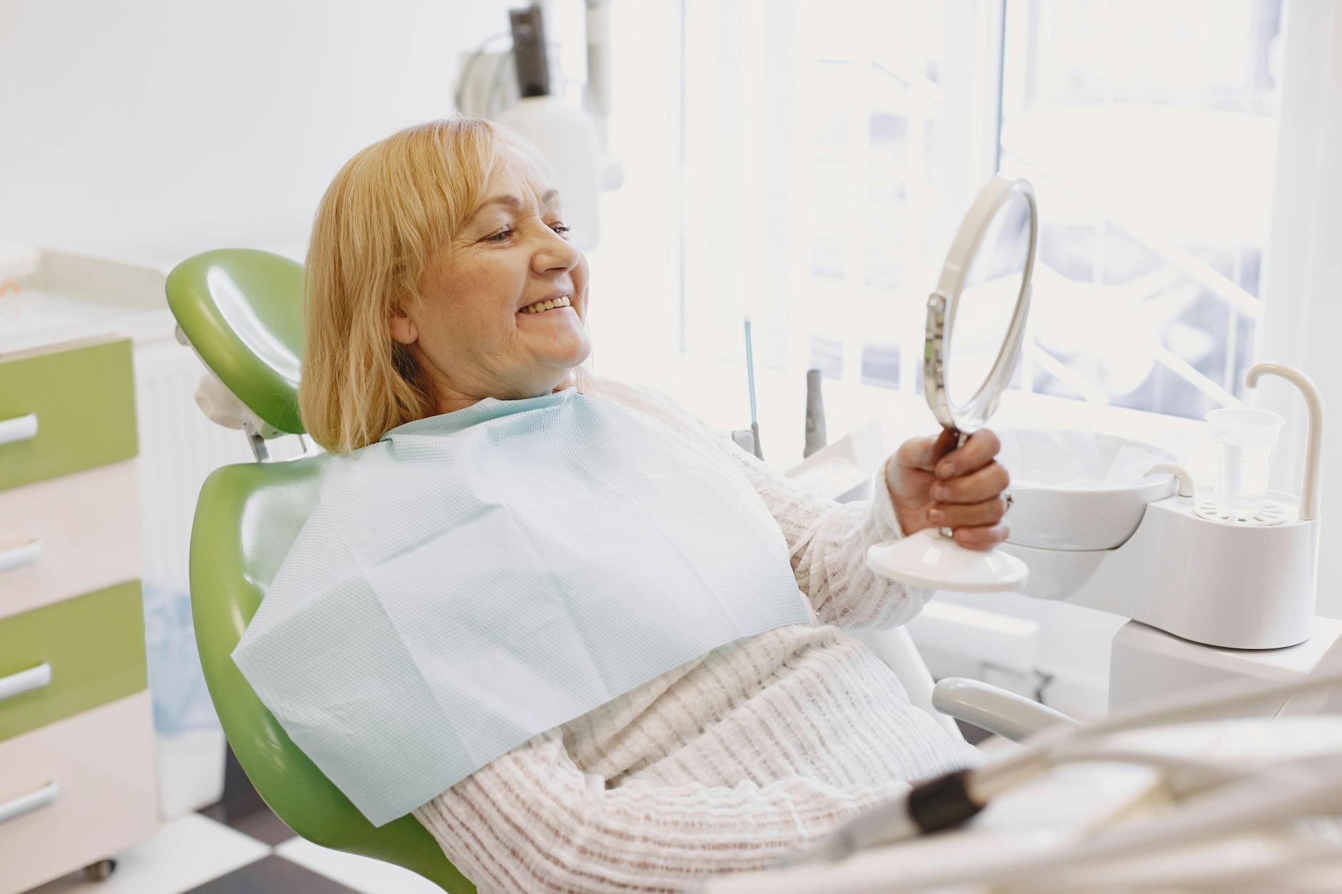 happy senior patient smiling after tooth replacement