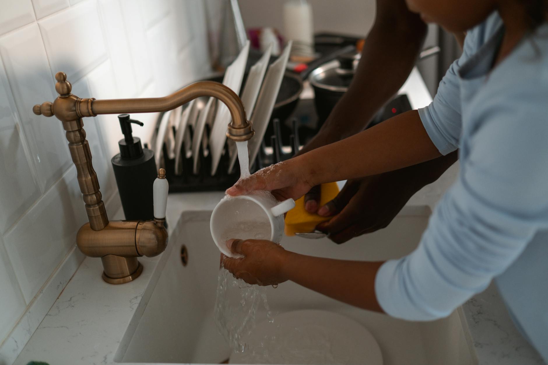 family drinking tap water kitchen Overland Park home