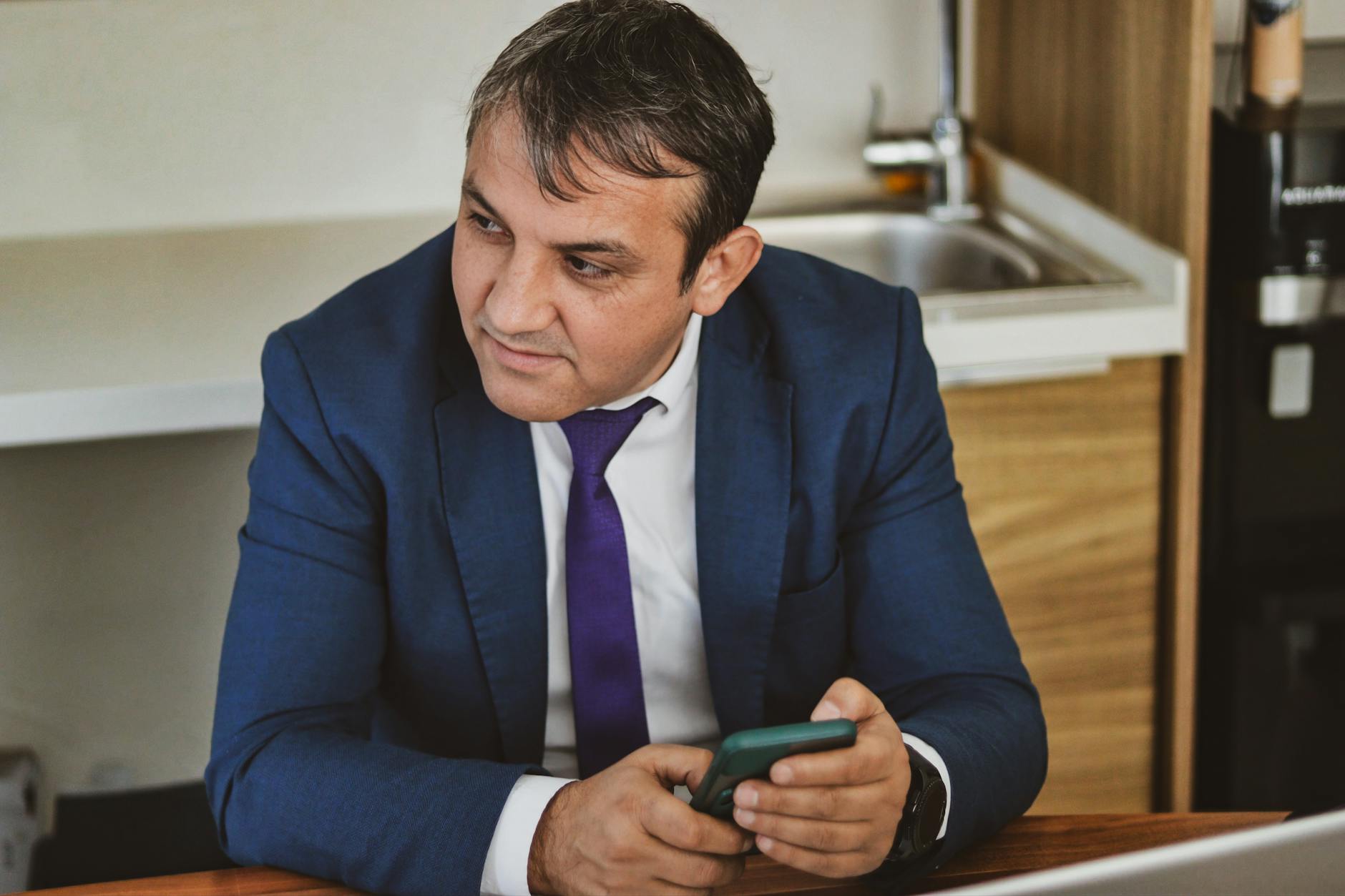 middle-aged businessman removing invisible braces at office