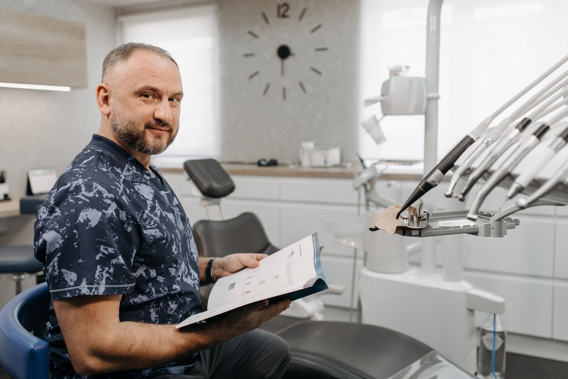 professional dentist with MAGD certificate in modern dental office