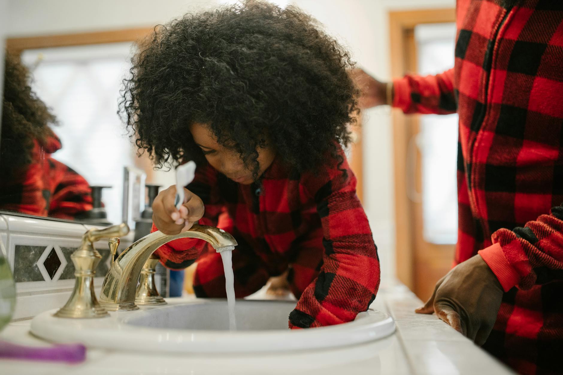 children brushing teeth bathroom sink Kansas