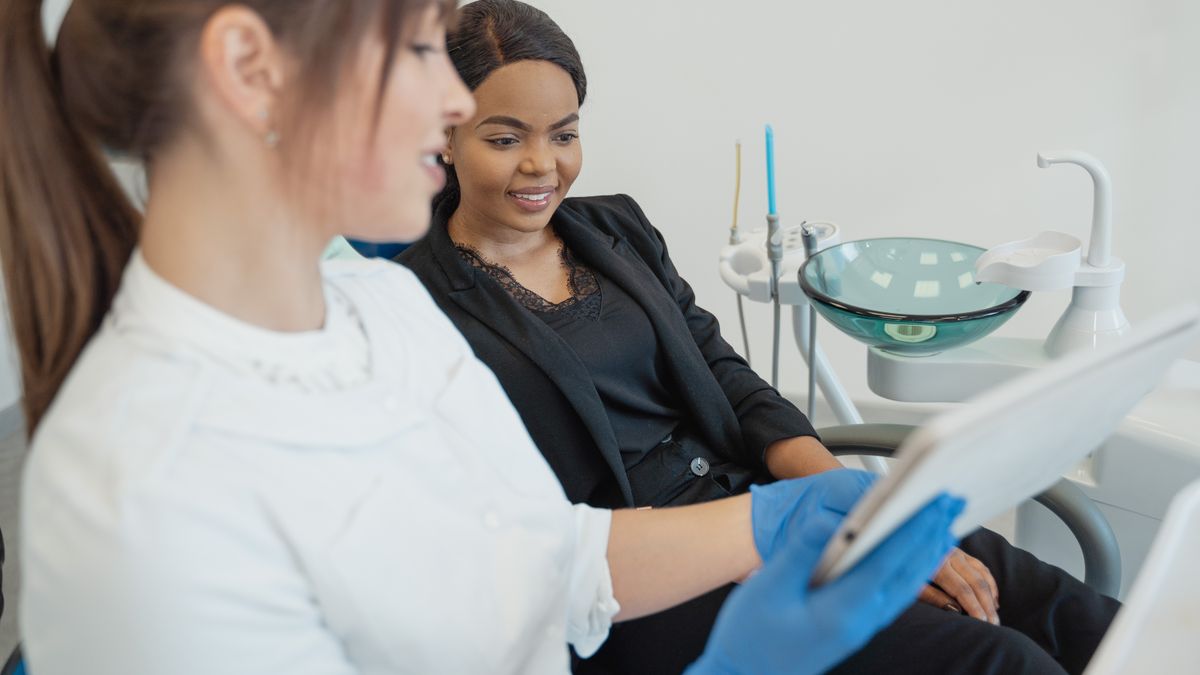 Dental team member going through a treatment plan with a patient