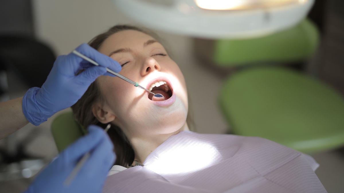 Patient having their teeth examined in a dental chair