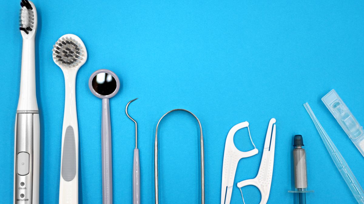 Flat lay of toothbrush, floss and interdental cleaning tools