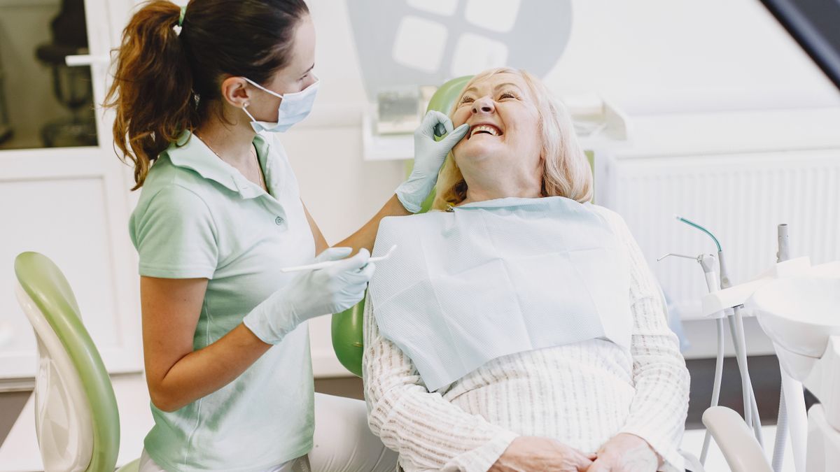 Dental hygienist and patient talking during a routine checkup