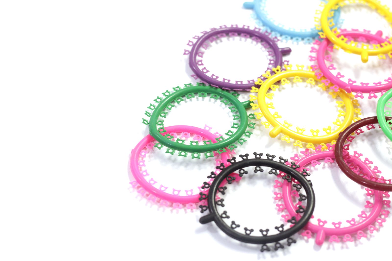 A vibrant mix of orthodontic braces bands in various colors on a white background