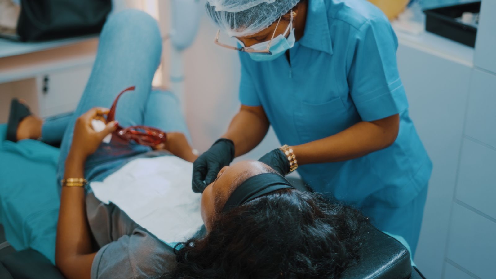 Dental professional attending to a patient in a clinic in Lagos, Nigeria
