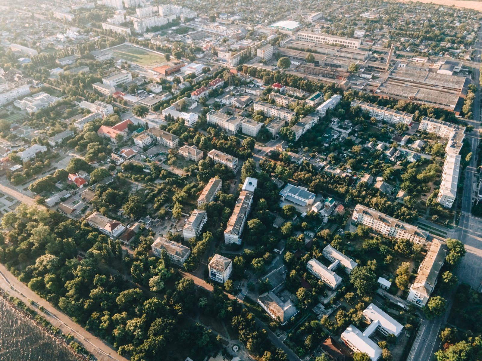 Aerial view of urban cityscape with residential buildings, roads, and greenery