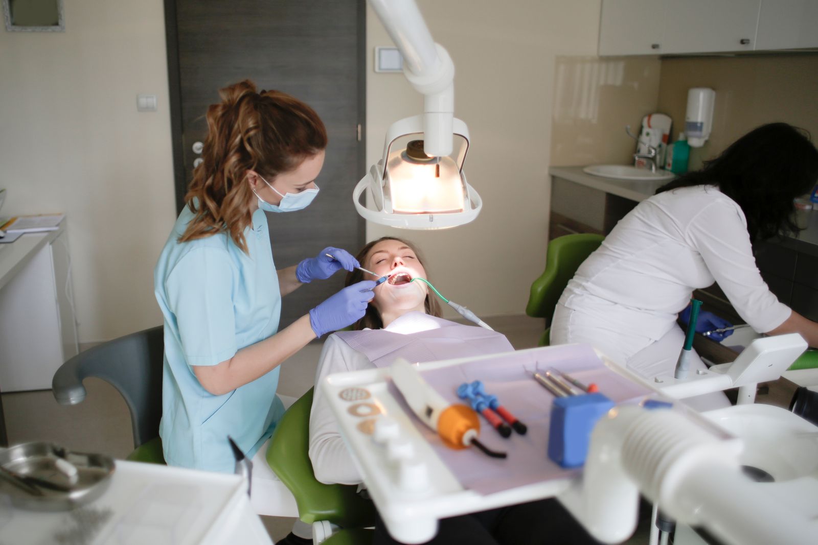 A dentist conducts a dental checkup on a patient in a modern clinic, focusing on oral hygiene