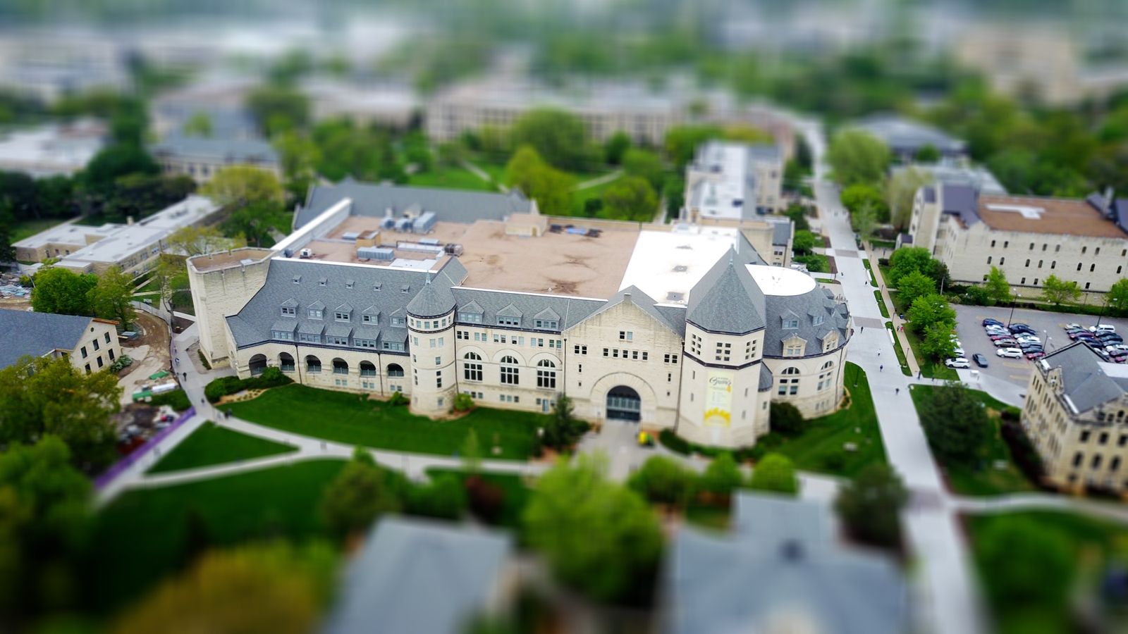 Aerial view of a university campus in Manhattan, Kansas, showcasing modern architecture and lush greenery
