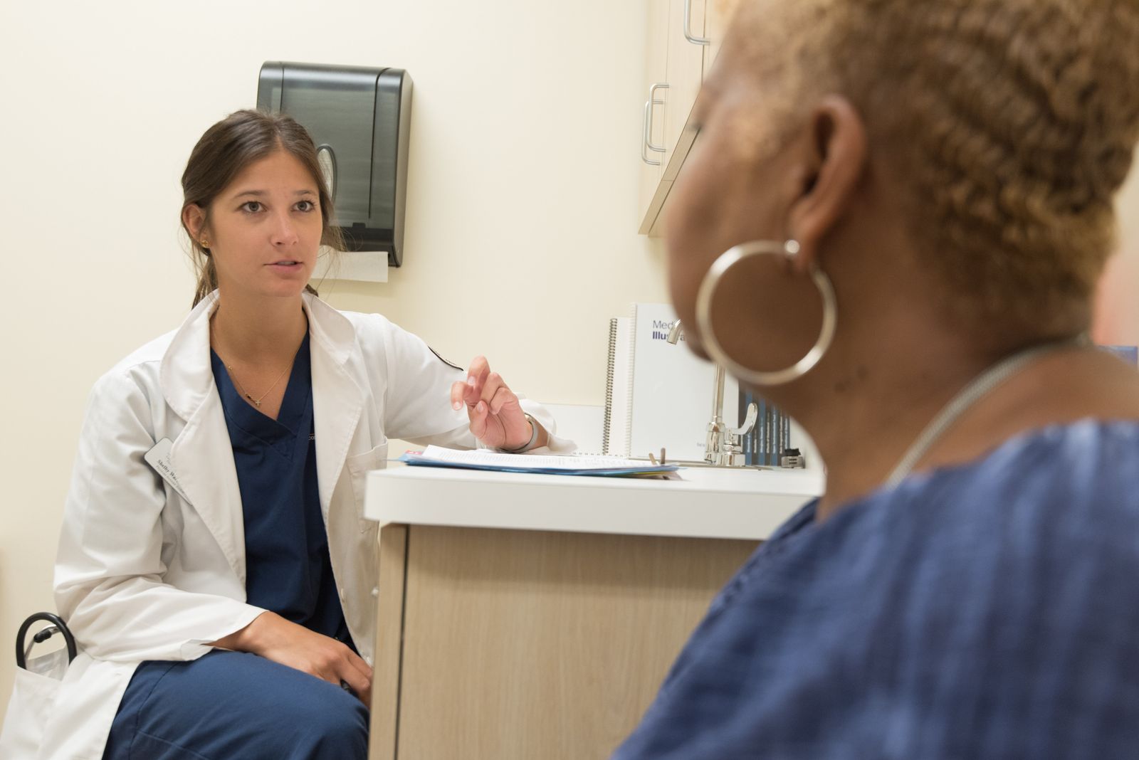 Doctor in consultation with patient at a medical clinic, discussing treatment options