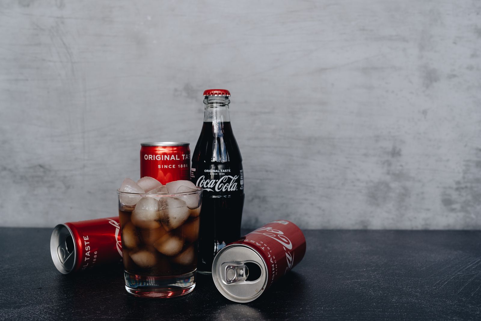 Chilled Coca-Cola bottles and cans with ice, offering a refreshing drink experience