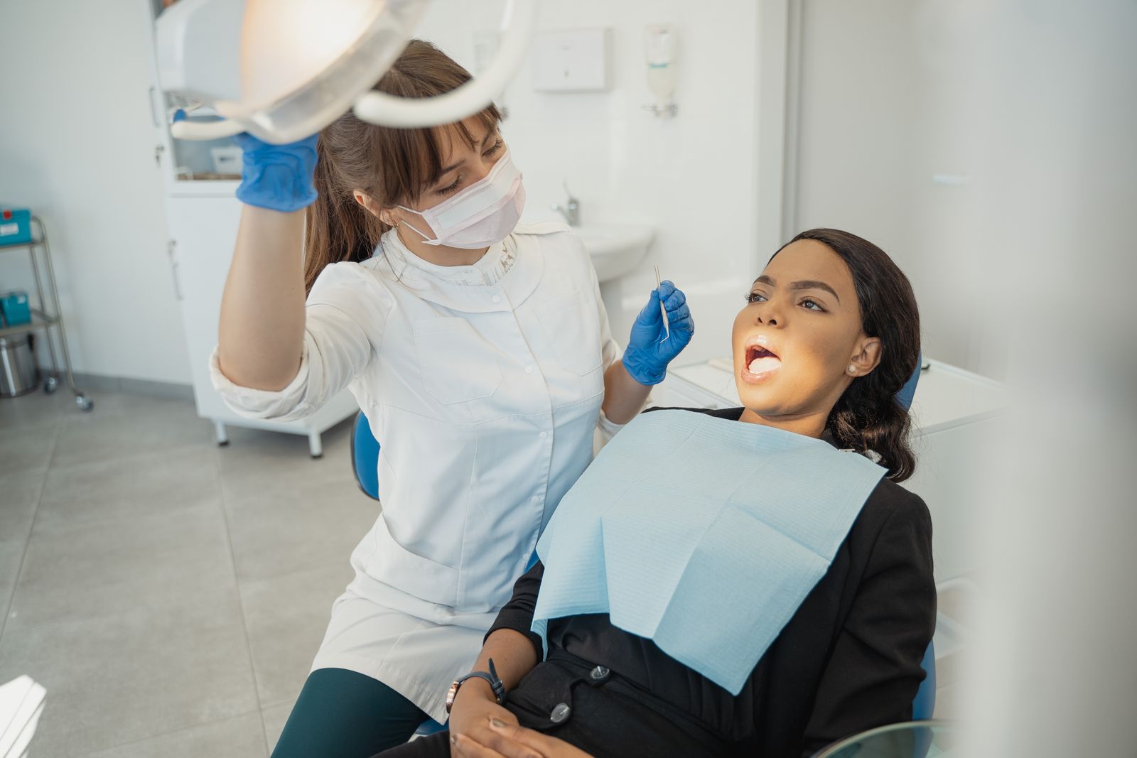 Dentist in a modern clinic providing dental care to a patient during exam