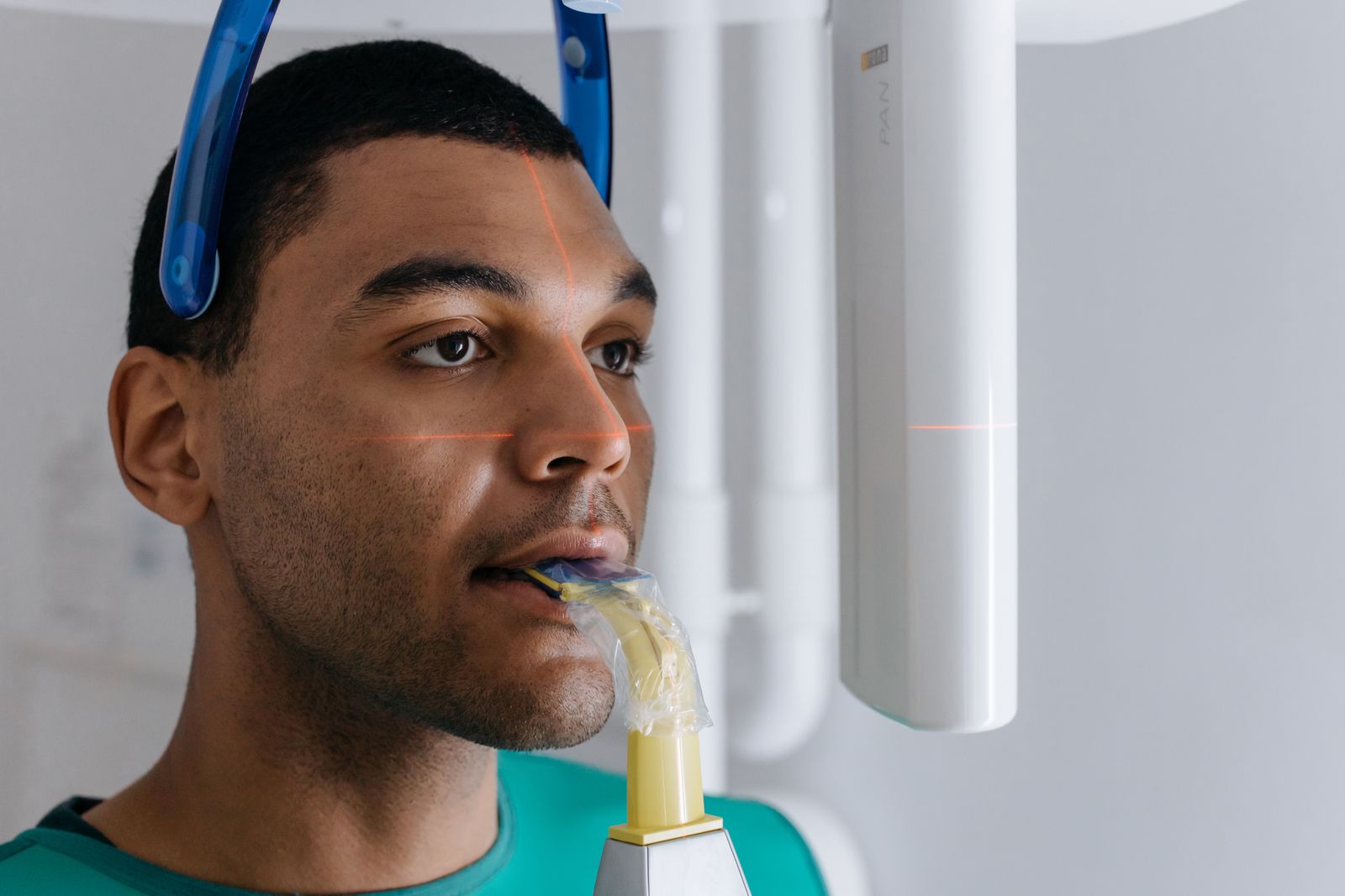 Close-up of a man having a dental x-ray in a clinic, showing modern odontology practices