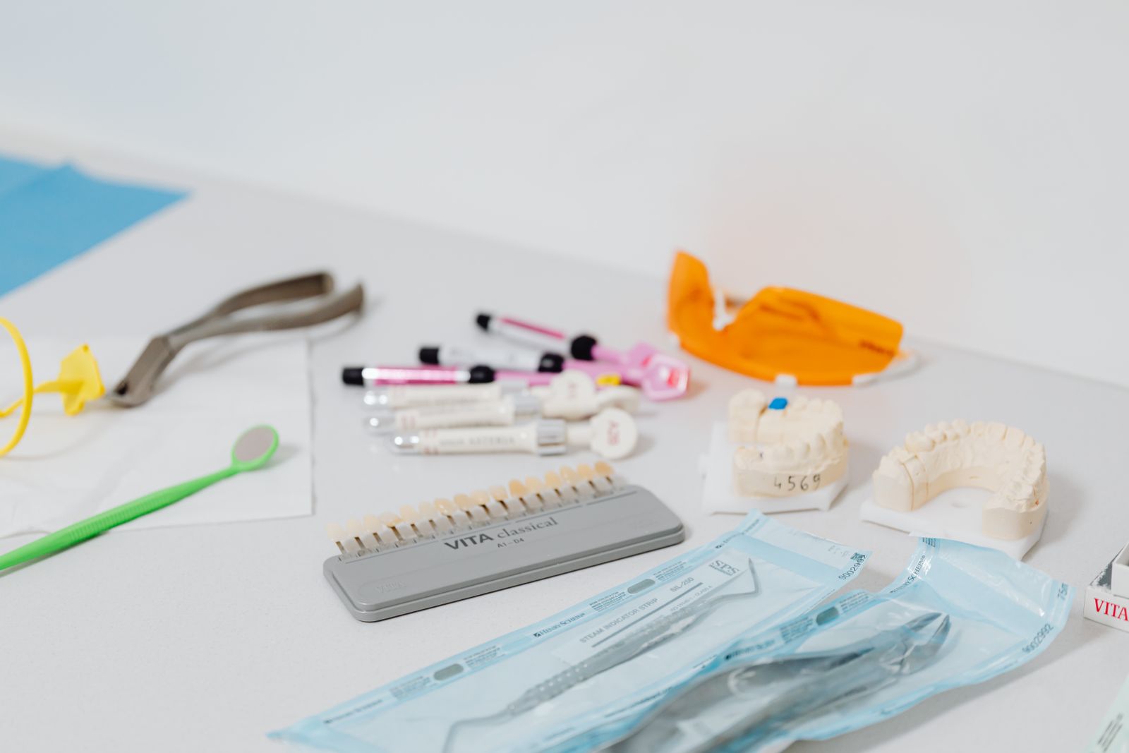 Close-up of various dental tools and models used for dentistry displayed on a table