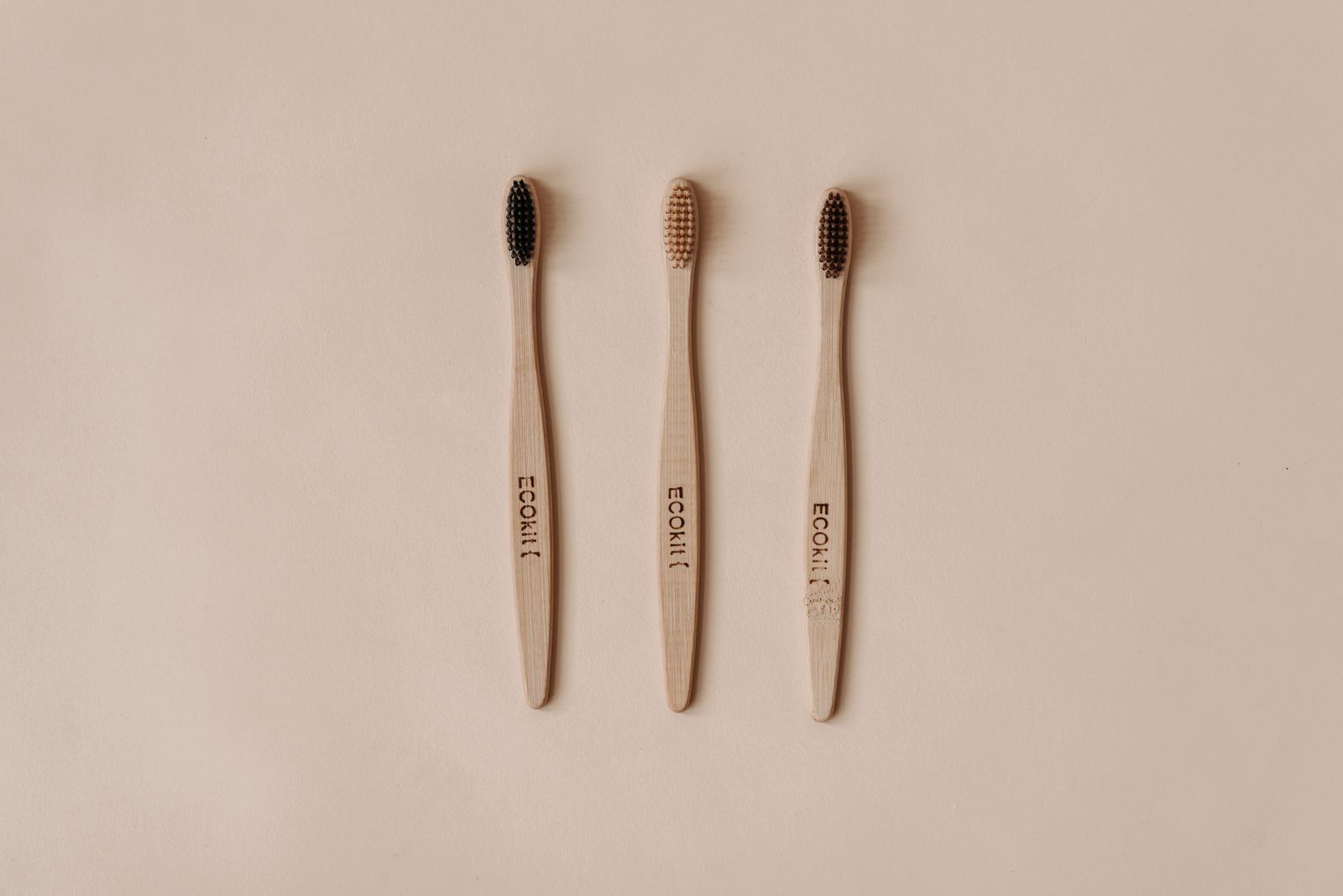 Minimalist flat lay of sustainable wooden toothbrushes promoting eco-friendly dental care