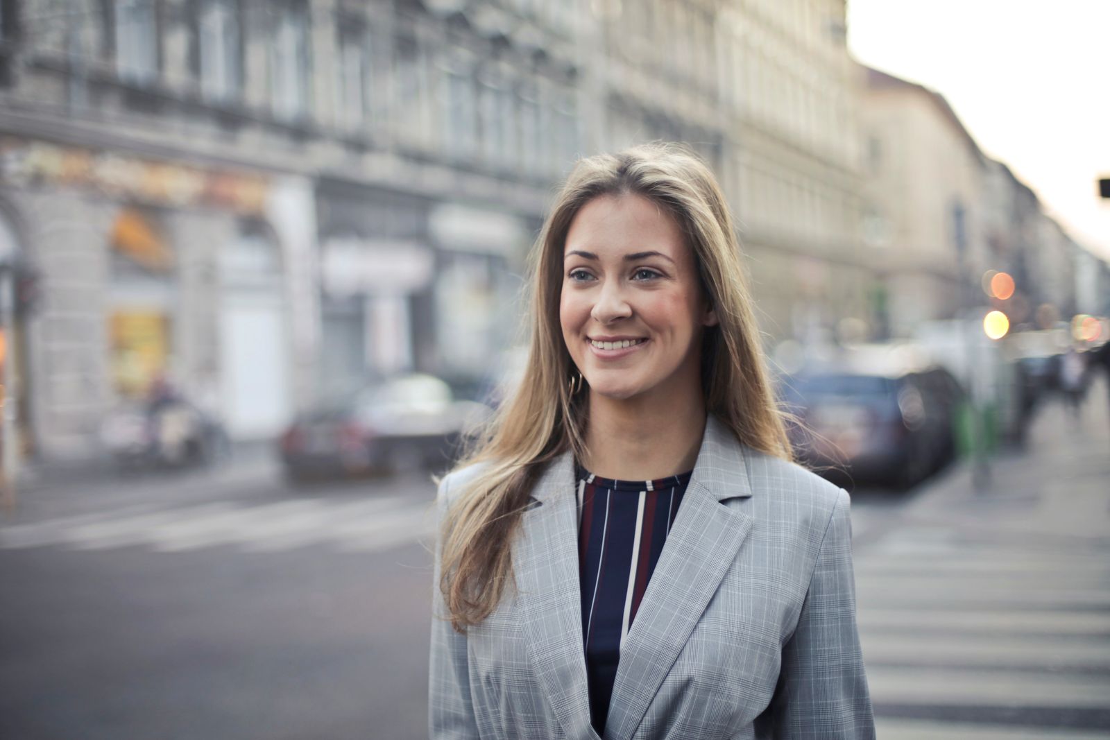 Confident businesswoman smiling outdoors in urban Budapest setting