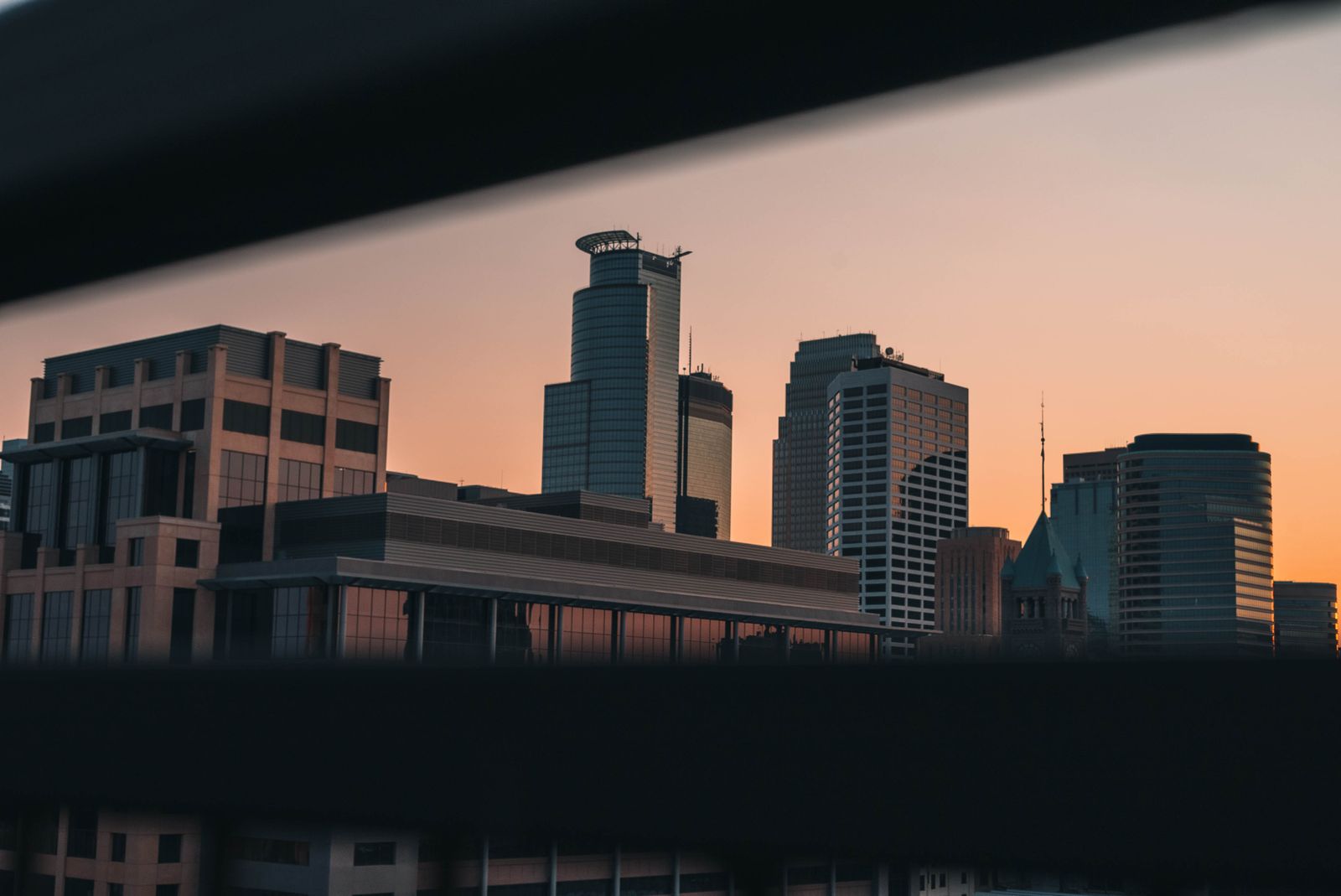 Captivating view of Minneapolis skyline during sunset, showcasing modern architecture in a serene twilight
