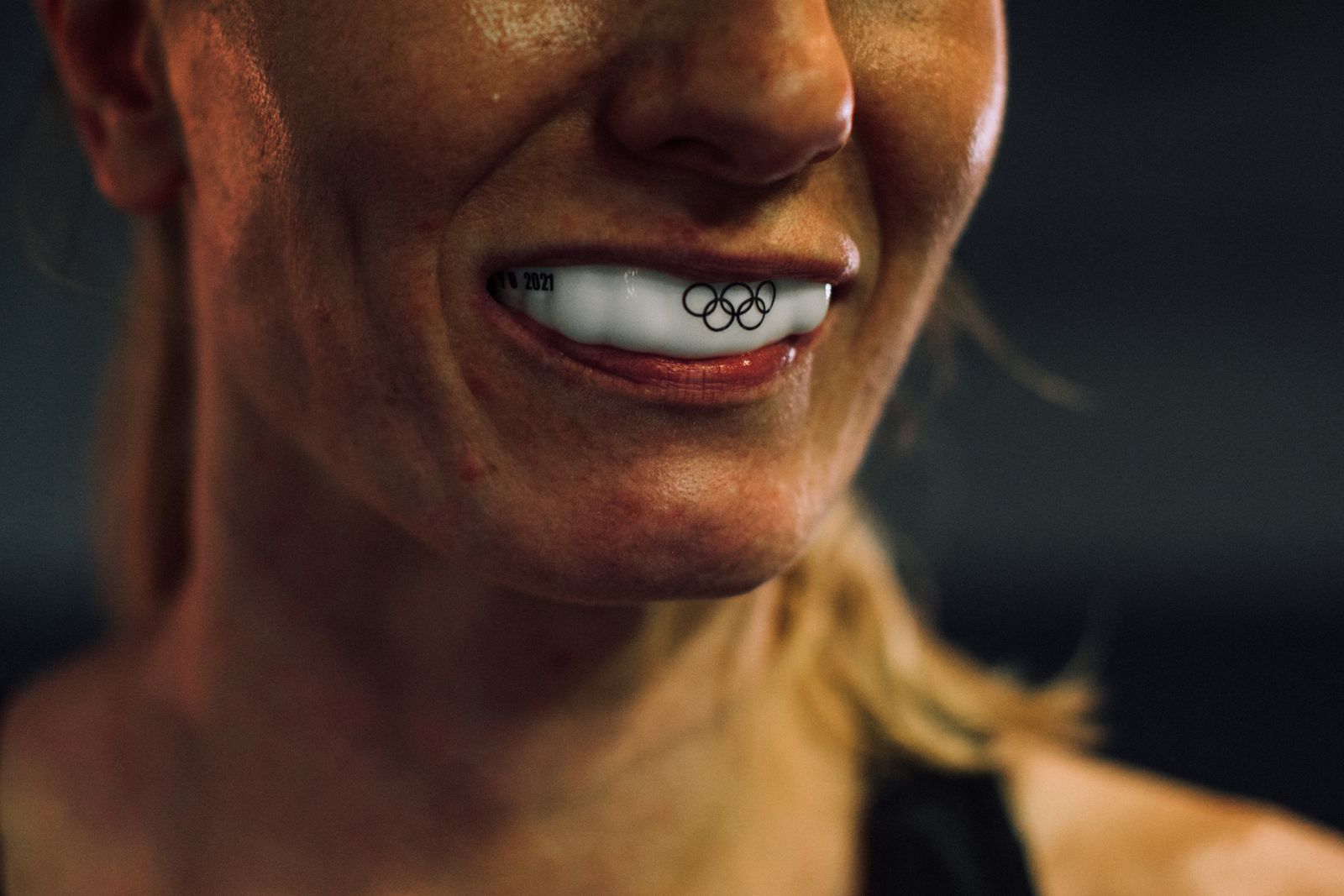 Close-up shot showcasing an athlete's mouthguard with Olympic rings engraving
